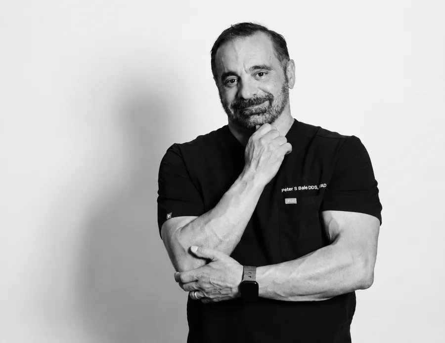 Black-and-white hand-on-chin portrait of Dr. Peter S. Balle